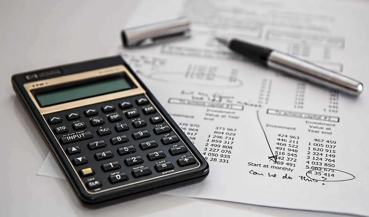 a calculator on a paper, illustrating the insurance brokers