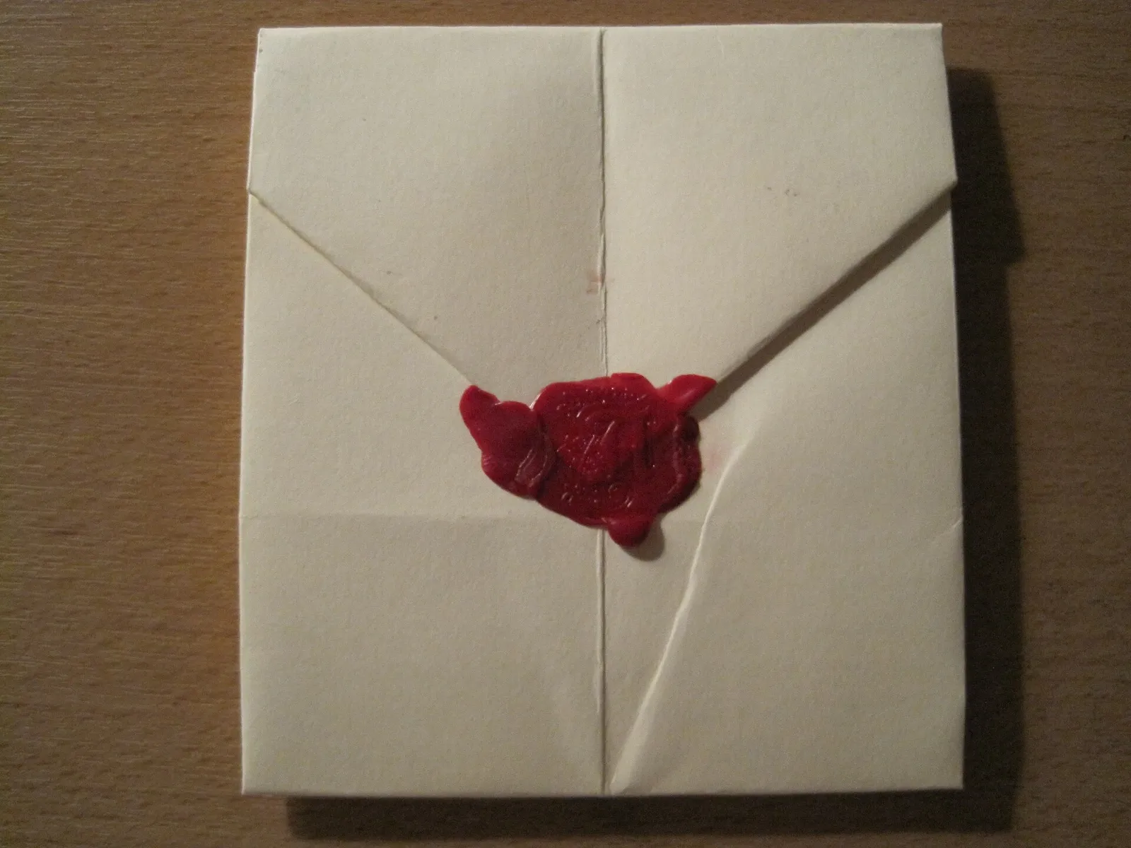 A hand-folded letter sealed with red wax