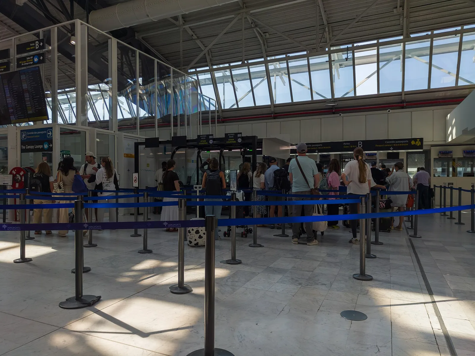 Travellers queuing at passport control in Nice airport