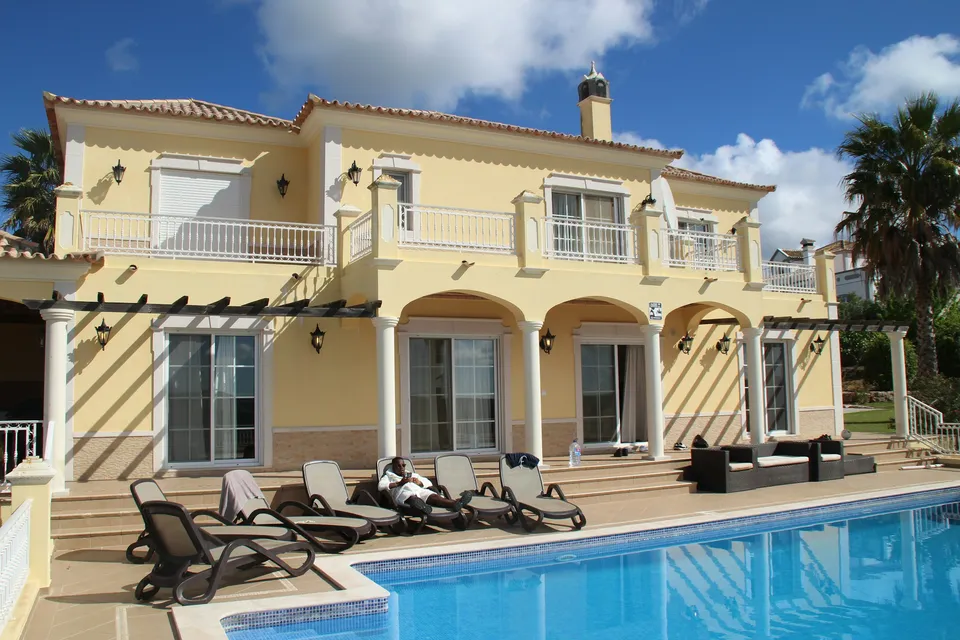 A sunny villa with a terrace and a swimming pool